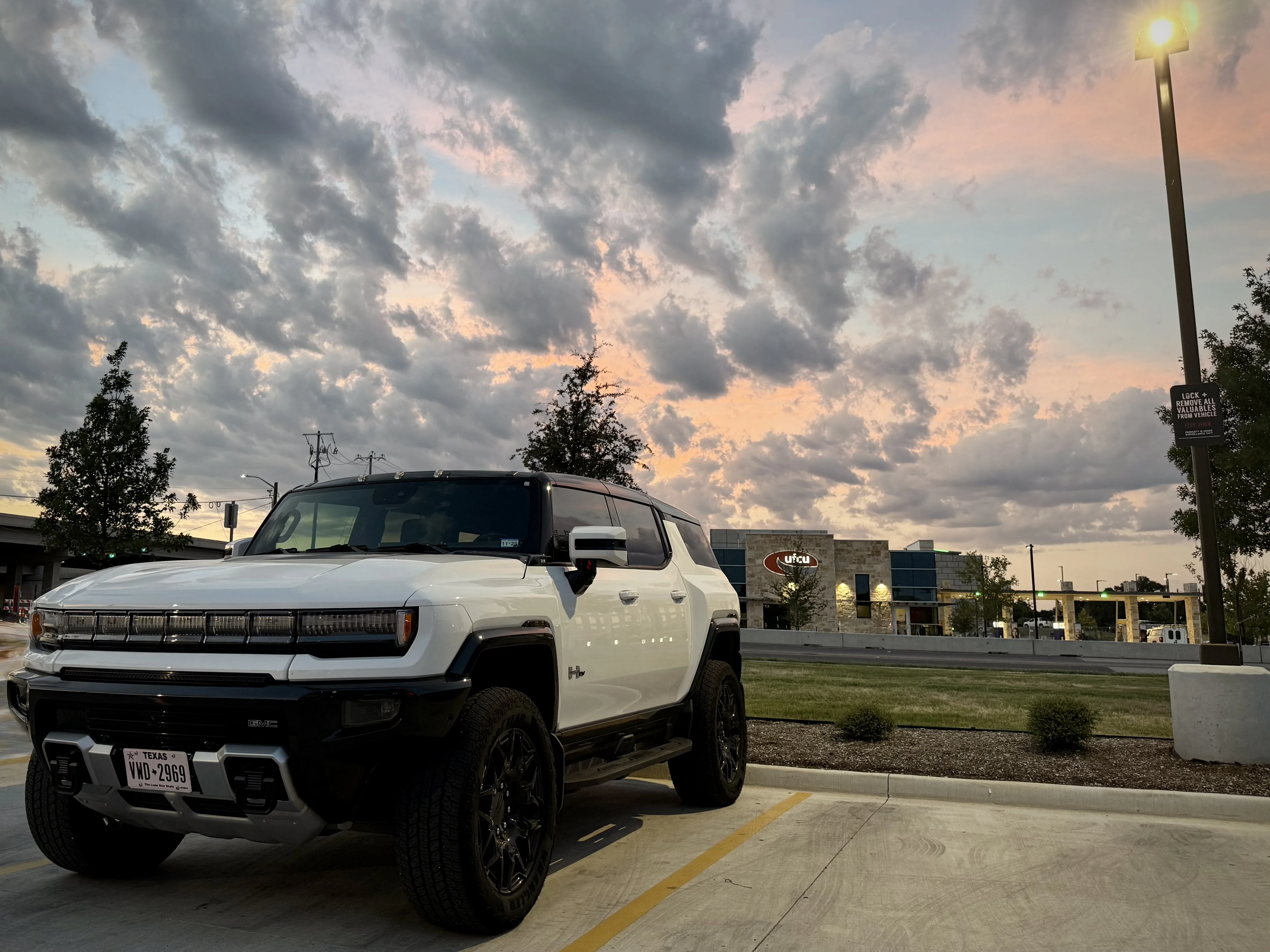 white-hummer-ev-sunset.webp