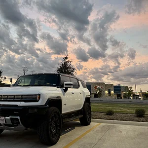 white-hummer-ev-sunset.webp